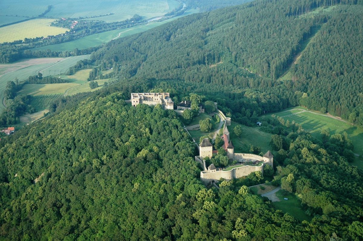 View from the west of a protruding peak of the Maleník Massif, on which Helfštýn Castle was built. The image illustrates the difference in altitude between the high plain of the castle hill and the levelled surface of the Bečva Gate. Krásnice Hill can be seen on the right of Helfštýn.